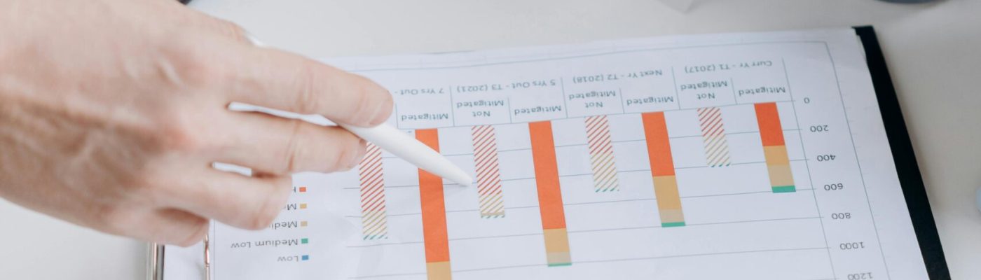pexels-photo-6592681-6592681 Hands pointing at performance charts during a business meeting.